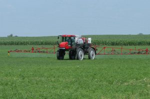 Red sprayer in field
