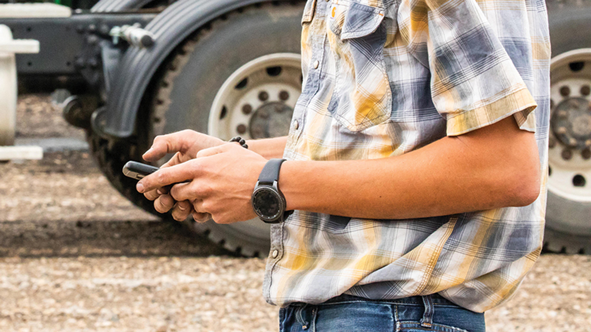 Man's arms holding smartphone
